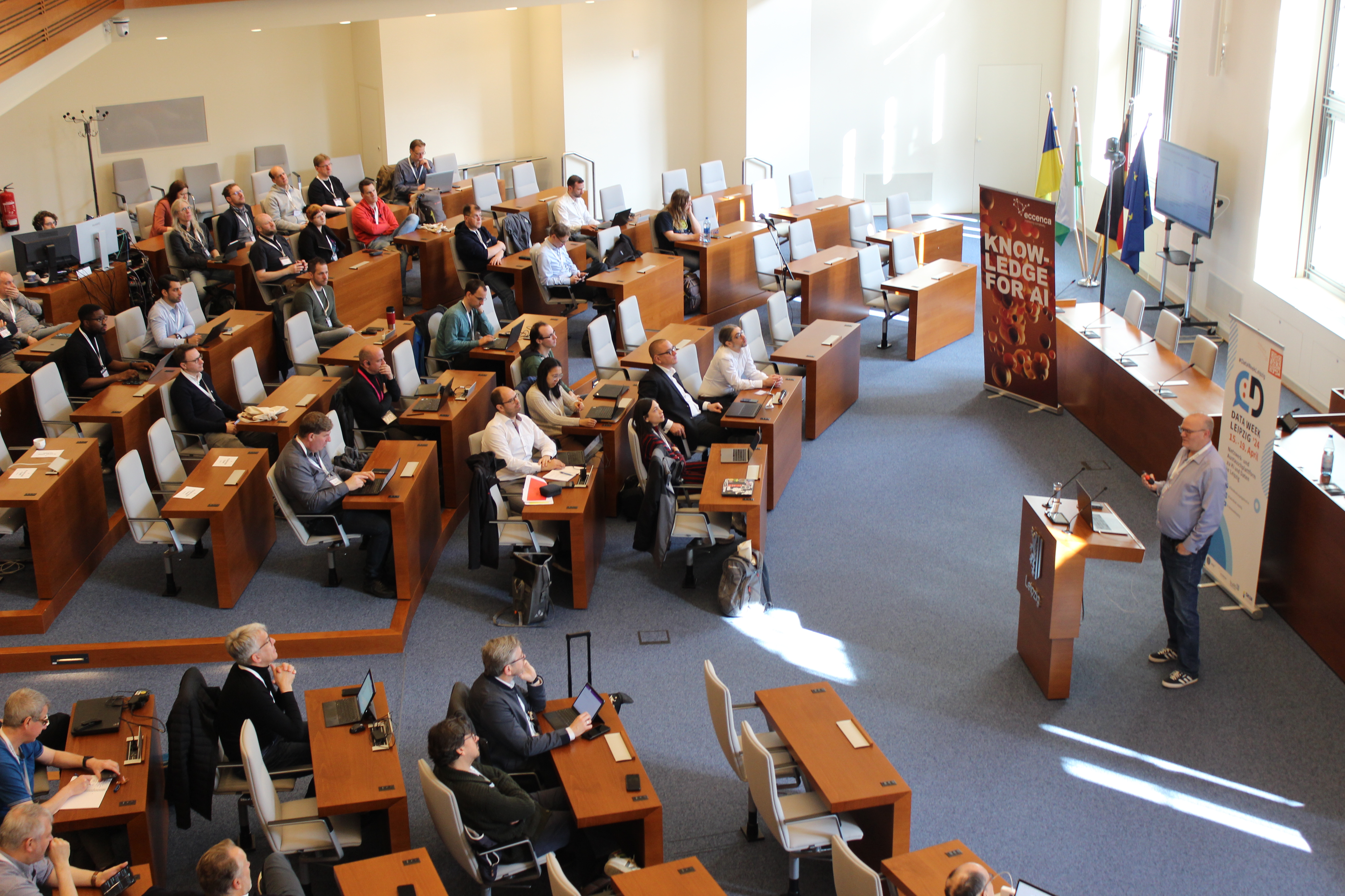 Image of a talk in front of the audience at Sitzungssaal